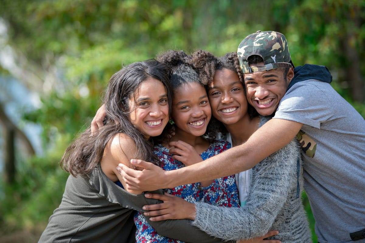 Friends and family hugging and laughing together