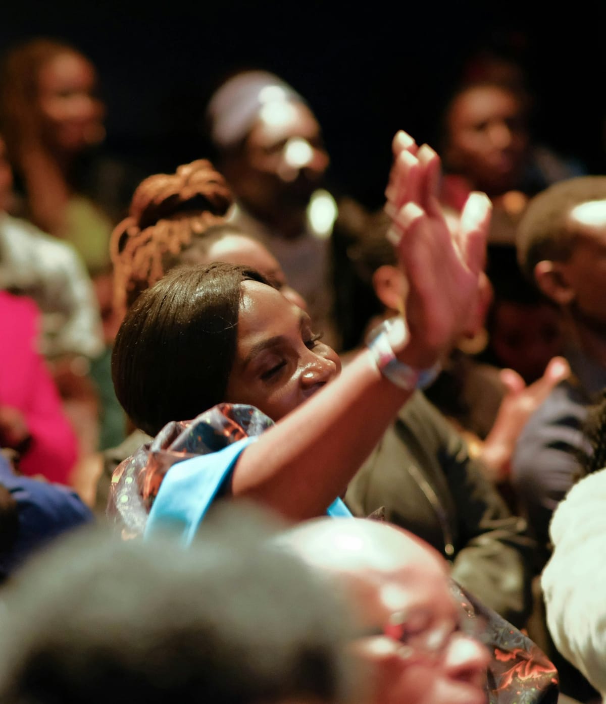 A woman praying with others around her