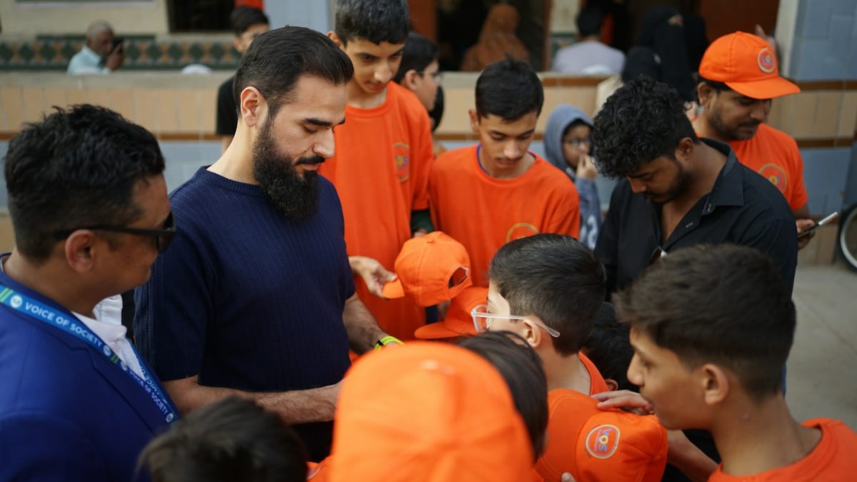 Volunteers handing out orange caps